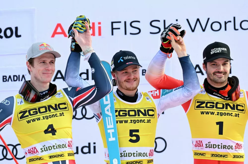 Alpine Skiing - FIS Alpine Ski World Cup - Men's Slalom - Alta Badia, Italy - December 22, 2025 Norway's Atle Lie McGrath celebrates during the medal ceremony after winning Men's Slalom along with second placed France's Clement Noel and third placed Switzerland's Loic Meillard REUTERS/Angelika Warmuth