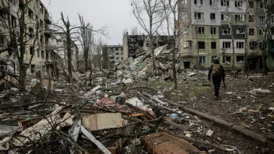 Ukrainian serviceman walks near apartment buildings damaged by Russian military strike, amid Russia's attack on Ukraine, in the frontline town of Kostiantynivka in Donetsk region, Ukraine December 20, 2025. Oleg Petrasiuk/Press Service of the 24th King Danylo Separate Mechanized Brigade of the Ukrainian Armed Forces/Handout via REUTERS ATTENTION EDITORS - THIS IMAGE HAS BEEN SUPPLIED BY A THIRD PARTY.