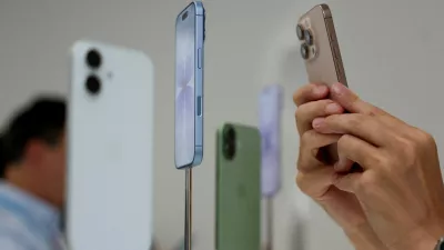 FILE PHOTO: A person uses a phone to capture iPhones on display during Apple's event at the Steve Jobs Theater in Cupertino, California, U.S. September 9, 2025. REUTERS/Manuel Orbegozo/File Photo