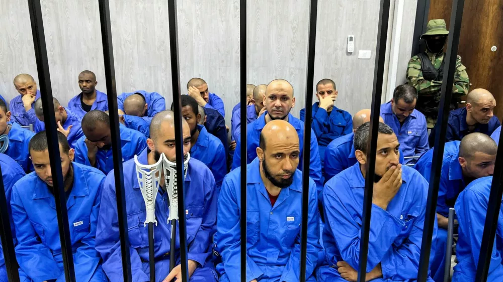 ISIS suspects sit behind bars in the court in Misrata, Libya August 8, 2022. REUTERS/Ayman al-Sahili