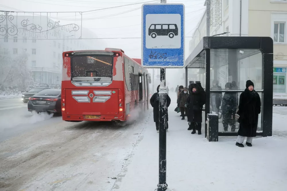 RUSSIA, YAKUTSK - DECEMBER 12, 2025: People are seen at a bus stop amid temperatures plunging as low as -45C [-43F],Image: 1058704172, License: Rights-managed, Restrictions: * Switzerland And Russia Rights Out *, Model Release: no