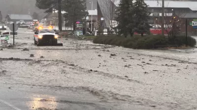 A vehicle moves through a flooded street during torrential rains, in San Bernardino County, California, U.S. December 24, 2025, in this screengrab obtained from a social media video. Damian Nikodem/via REUTERS THIS IMAGE HAS BEEN SUPPLIED BY A THIRD PARTY. MANDATORY CREDIT. NO RESALES. NO ARCHIVES.  VERIFICATION LINES: - Reuters was able to verify the location and date of the video from original file metadata from the source. - The buildings, road layout and business signages matched file imagery of the area.