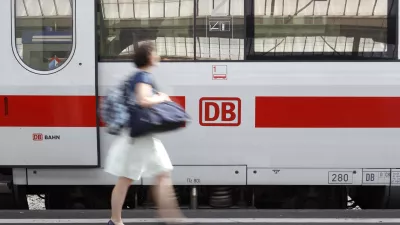 A woman walks past a German railway Deutsche Bahn (DB) train at Zurich main railway station July 9, 2010. Swiss Federal Railways (SBB) and DB signed today a memorandum of understanding to reinforce their cooperation. REUTERS/Arnd Wiegmann (SWITZERLAND - Tags: BUSINESS TRANSPORT TRAVEL)
