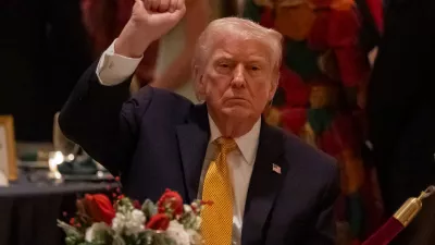 President Donald Trump pumps his fist at Christmas Eve dinner at his Mar-a-Lago club, Wednesday, Dec. 24, 2025, in Palm Beach, Fla. (AP Photo/Alex Brandon)