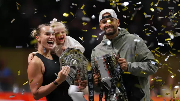 Tennis - 'Battle of the Sexes' - Nick Kyrgios v Aryna Sabalenka - Coca-Cola Arena, Dubai, United Arab Emirates - December 28, 2025 Belarus' Aryna Sabalenka, her goddaughter Nicole, and Australia's Nick Kyrgios celebrate with trophies after the match REUTERS/Amr Alfiky/Pool