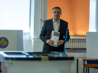 Kosovo's acting prime minister and leader of VeteVendosje political party Albin Kurti holds his ballot in Kosovo's capital Pristina, Sunday Dec. 28, 2025. (AP Photo/Visar Kryeziu)