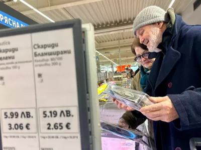 FILE PHOTO: People shop in a Lidl store, as prices are displayed in both the Bulgarian lev and euro currencies, ahead of Bulgaria's adoption of the euro on January 1, 2026, in Sofia, Bulgaria, December 18, 2025. REUTERS/Fedja Grulovic/File Photo