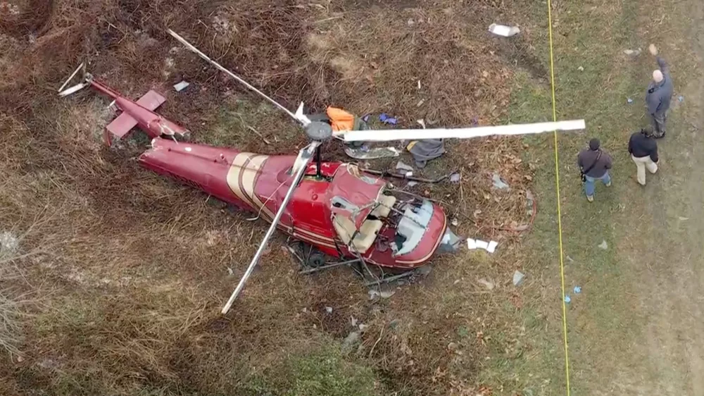 Authorities look over the scene after two helicopters crashed in Hammonton, N.J., on Sunday, Dec. 28, 2025. (WPVI-TV/6ABC via AP)