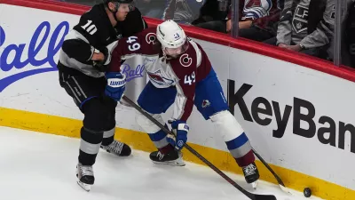 Los Angeles Kings right wing Corey Perry, left, fights for control of the puck with Colorado Avalanche defenseman Samuel Girard in the third period of an NHL hockey game Monday, Dec. 29, 2025, in Denver. (AP Photo/David Zalubowski)