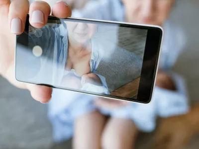 mother breastfeeding mobile photo newborn baby concept. family memories selfie.
