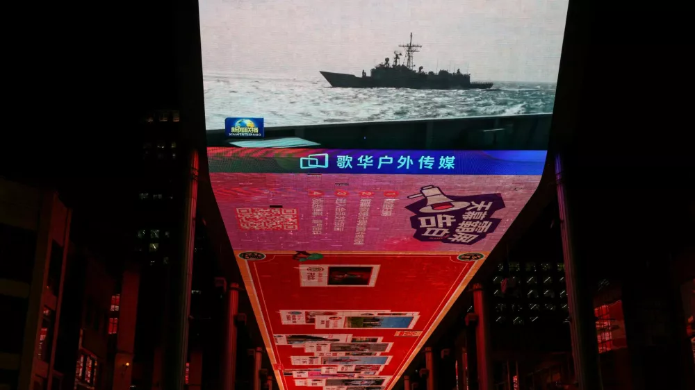 A giant screen shows a news report on China's "Justice Mission 2025" military drills around Taiwan, in Beijing, China December 30, 2025. REUTERS/Tingshu Wang