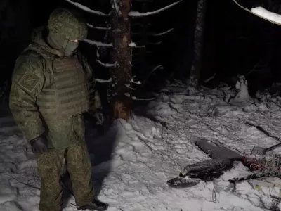 A Russian service member stands next to the remains of a drone, which, according to the Russian Defence Ministry, was downed during the repelling of an alleged Ukrainian attack on the Russian presidential residence in the Novgorod Region, in an unknown location in Russia, in this still image from a video released December 31, 2025. Russian Defence Ministry/Handout via REUTERS ATTENTION EDITORS - THIS IMAGE WAS PROVIDED BY A THIRD PARTY. NO RESALES. NO ARCHIVES. MANDATORY CREDIT. WATERMARK FROM SOURCE.