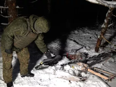 This image made from undated video provided by the Russian Defense Ministry Press Service on Wednesday, Dec. 31, 2025, shows a man in camouflage standing by a downed drone at an undisclosed location that it said was one of the Ukrainian drones involved in an alleged attack on a residence of President Vladimir Putin this week &ndash; a claim Kyiv has denied as a "lie". (Russian Defense Ministry Press Service via AP)