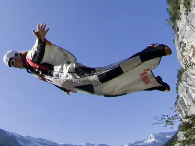 A base jumper leaps from a alpine cliff in the Lauterbrunnen valley in the Bernese Oberland, Switzerland August 13, 2009. Base jumping is the sport of using a parachute to jump a fixed object, either Building, Antenna, Span or Earth. The Lauterbrunnen valley has been used by base jumpers since 1997. Picture taken August 13, 2009. REUTERS/Pascal Lauener (SWITZERLAND SPORT SOCIETY)