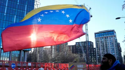 A man from the Communist Party of Britain (CPB) group holds the Venezuelan flag outside the U.S. Embassy in London calling for "Hands off Venezuela!" after U.S. President Donald Trump said the U.S. has struck Venezuela and captured its President Nicolas Maduro and his wife Cilia Flores, in London, Britain, January 3, 2026. REUTERS/Carlos Jasso