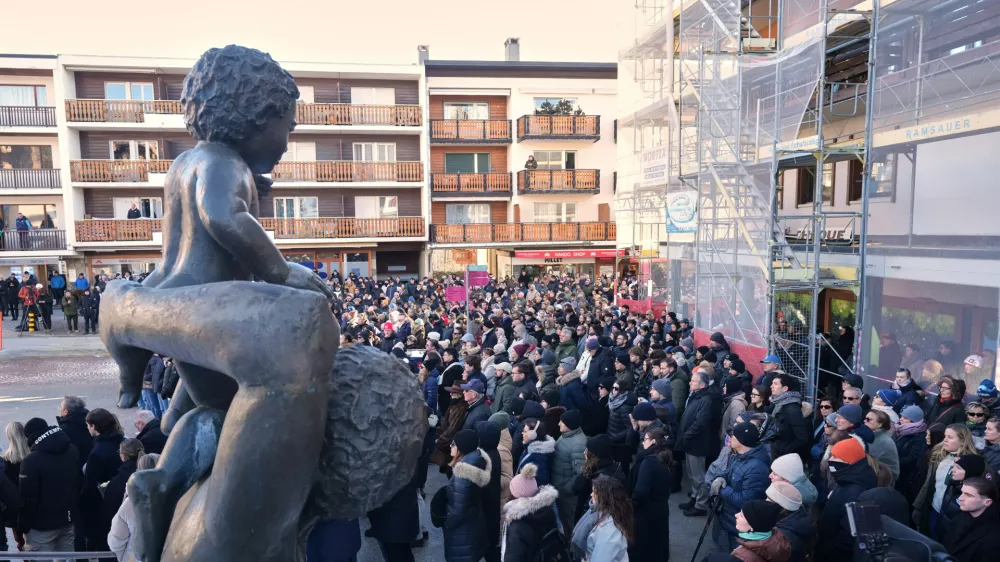 People stand outside the Chapelle St-Christophe during a memorial mass in Crans-Montana, Swiss Alps, Switzerland, Sunday, Jan. 4, 2026, after a devastating fire in Le Constellation bar left dead and injured during the New Year's celebrations. (AP Photo/ Antonio Calanni)