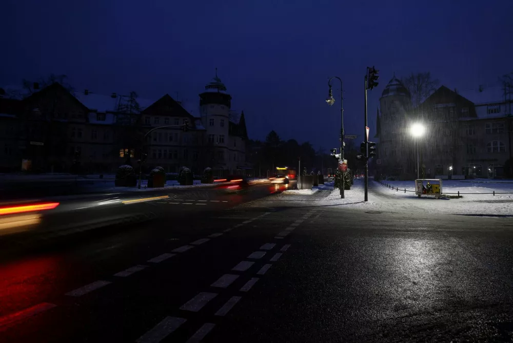 Cars pass the square where the members of THW (Technisches Hilfswerk, the Federal Agency for Technical Relief), set up lighting using a power generator, during a blackout, leaving thousands of homes without electricity after a suspected arson attack at the power plant Lichterfelde, in the district Steglitz-Zehlendorf, in southern Berlin, Germany, January 4, 2026. REUTERS/Lisi Niesner