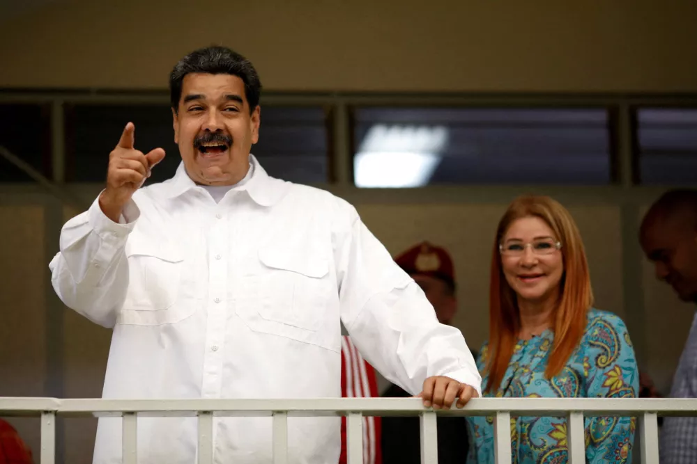 FILE PHOTO: Venezuela's President Nicolas Maduro talks to the media next to his wife Cilia Flores after taking part in a voting drill, ahead of May 20 presidential election, in Caracas, Venezuela May 6, 2018. REUTERS/Carlos Garcia Rawlins/File Photo