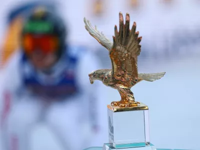 Ski Jumping - Four Hills Tournament - Innsbruck, Austria - January 4, 2026 General view of the trophy on display as Switzerland's Sandro Hauswirth in action during his jump REUTERS/Kai Pfaffenbach