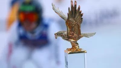 Ski Jumping - Four Hills Tournament - Innsbruck, Austria - January 4, 2026 General view of the trophy on display as Switzerland's Sandro Hauswirth in action during his jump REUTERS/Kai Pfaffenbach
