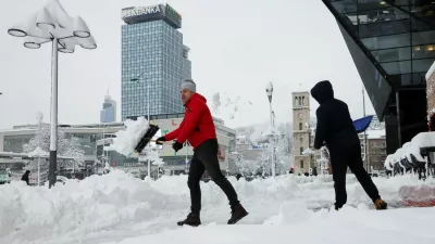 People clear snow from a street in Sarajevo, Bosnia and Herzegovina, January 5, 2026. REUTERS/Amel Emric