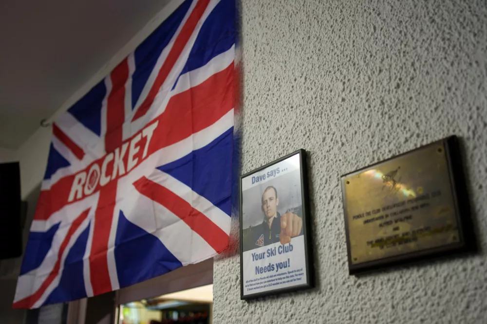 A flag and picture referencing Dave Riding, widely considered to be the greatest British alpine skier adorns the walls at Pendle Ski Club where he started his skiing journey, Clitheroe, England, Tuesday, Oct. 28, 2025. (AP Photo/Jon Super)