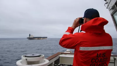 HANDOUT - 07 January 2026, ---: A handout photo taken from the X account of US European Command @US_EUCOM showing a member of the US Coast Guard observing a Venezuela-linked oil tanker which is travelling off British waters. US forces are reportedly attempting to seize the Marinera, a Russian-flagged vessel previously known as Bella-1, which is said to have escaped Donald Trump's "total naval blockade" of Venezuela. Photo: @us_Eucom/X/PA Media/dpa - ATTENTION: editorial use only and only if the credit mentioned above is referenced in full