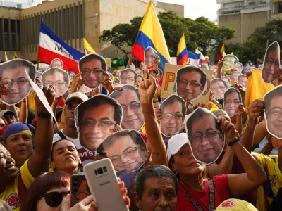 07 January 2026, Colombia, Cali: Demonstrators hold cutout faces of president Gustavo Petro as the Colombian President speaks during a rally in defence of national sovereignty in Cali, after US President Donald Trump suggested the United States might intervene militarily in Colombia, days after US forces struck Venezuela and captured Venezuelan President Nicolas Maduro and his wife Cilia Flores. Photo: Sebastian Marmolejo/LongVisual via ZUMA Press Wire/dpa