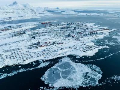 FILE - Houses covered by snow are seen on the coast of a sea inlet of Nuuk, Greenland, on March 7, 2025. (AP Photo/Evgeniy Maloletka, File)