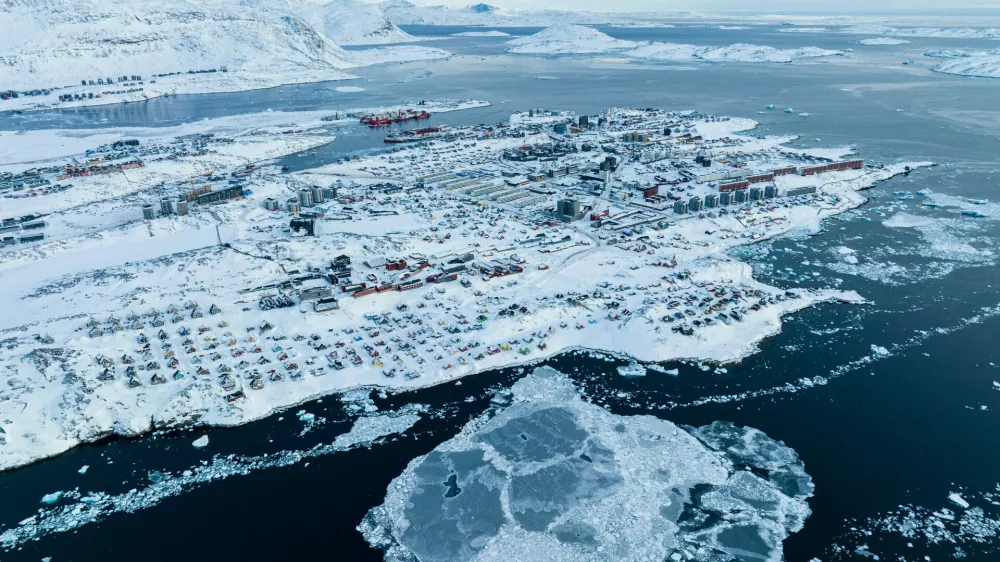 FILE - Houses covered by snow are seen on the coast of a sea inlet of Nuuk, Greenland, on March 7, 2025. (AP Photo/Evgeniy Maloletka, File)
