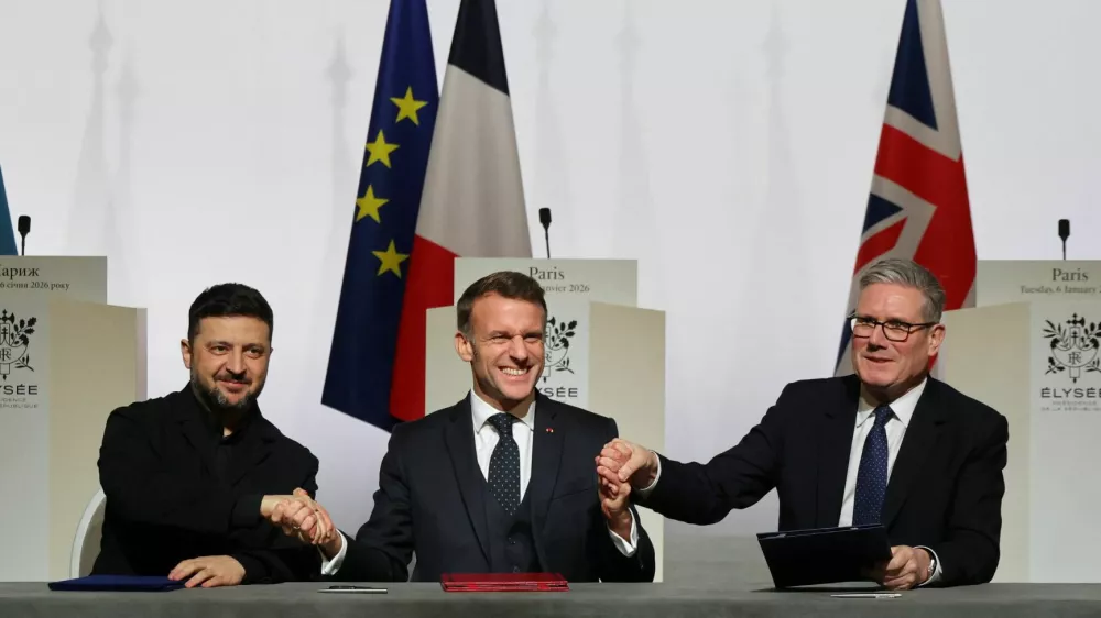 Ukraine's President Volodymyr Zelenskiy, France's President Emmanuel Macron and Britain's Prime Minister Keir Starmer shake hands upon the signing of the declaration on deploying post-ceasefire force in Ukraine during the so-called 'Coalition of the Willing' summit, at the Elysee Palace in Paris, France, January 6, 2026. Ludovic Marin/Pool via REUTERS