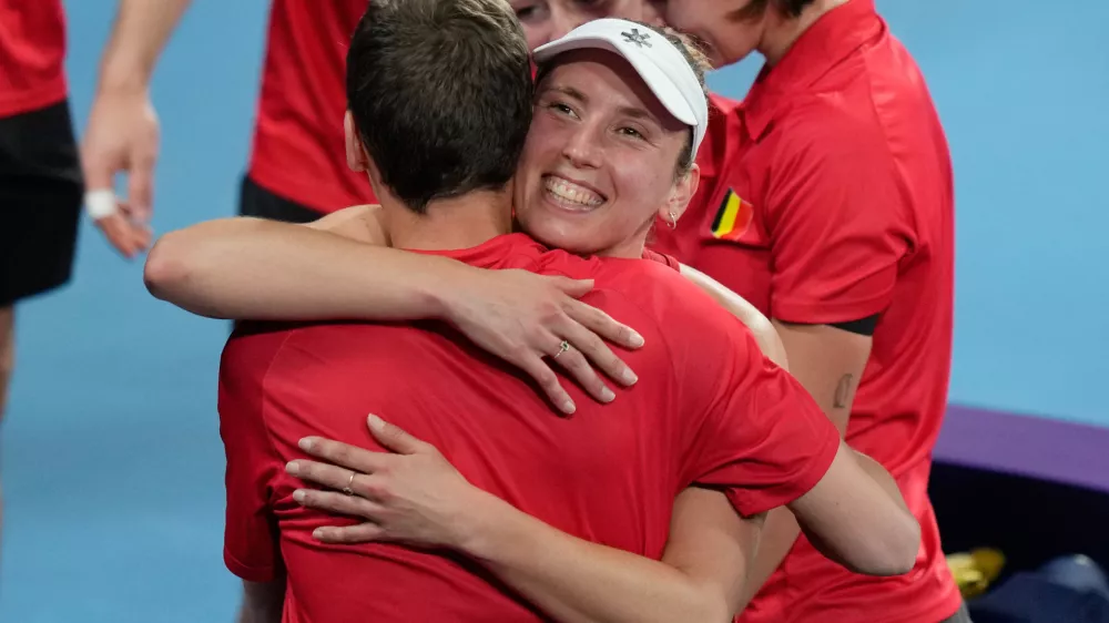 Elise Mertens of Belgium celebrates with teammates after her win over Barbora Krejcikova of Czechia in their women's singles quarterfinal match at the United Cup tennis tournament in Sydney, Thursday, Jan. 8, 2026. (AP Photo/Rick Rycroft)