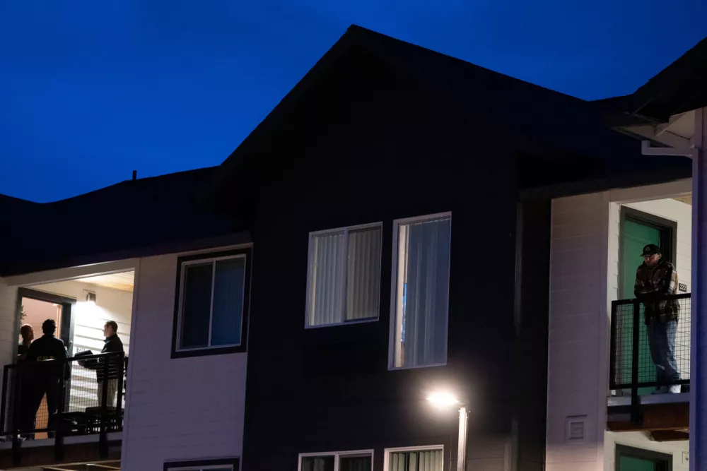 FBI agents interview residents, left, at the Bria Apartments after reports that federal immigration officers shot and wounded people in Portland, Ore., Thursday, Jan. 8, 2026. (Beth Nakamura/The Oregonian via AP)