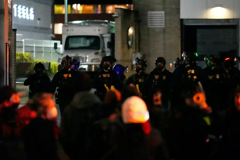 Protesters standoff against law enforcement outside the U.S. Immigration and Customs Enforcement facility on Thursday, Jan. 8, 2026, in Portland, Ore. (AP Photo/Jenny Kane)