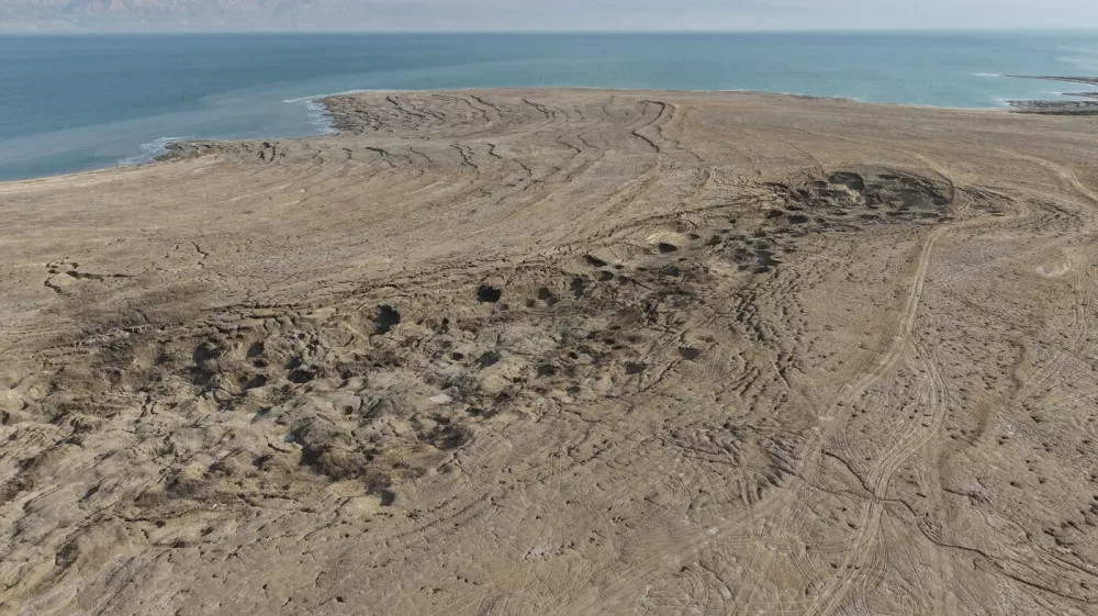 An aerial drone photo taken on January 4, 2026 shows a view of the sinkholes at the Dead Sea near Ein Gedi beach in Israel. Statistics showed that the Dead Sea had been shrinking at an alarming pace, its water level dropping by 1.2 meters each year. As the water receded, a barren landscape of salt rock and numerous sinkholes appeared. The proliferation of sinkholes along the Dead Sea shores remains one of Israel's most pressing environmental challenges. As of 2025, there are over 7,000 documented sinkholes, a number that continues to grow at a rate of several hundred per year.The rapid retreat of the Dead Sea is transforming the coastline and creating hazardous sinkholes.//04SIPA_sipa.41600/Credit:GIL COHEN-MAGEN/SIPA/2601071423,Image: 1063981066, License: Rights-managed, Restrictions:, Model Release: no