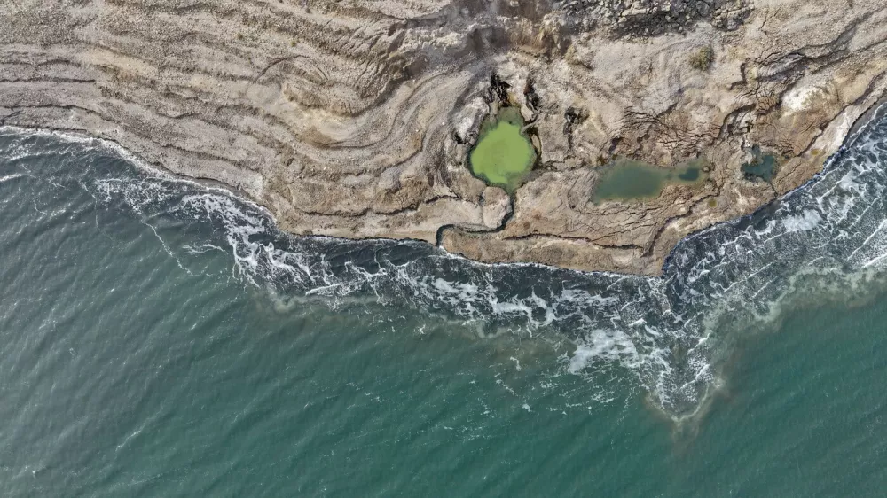 An aerial drone photo taken on January 4, 2026 shows a view of the sinkholes at the Dead Sea near Ein Gedi beach in Israel. Statistics showed that the Dead Sea had been shrinking at an alarming pace, its water level dropping by 1.2 meters each year. As the water receded, a barren landscape of salt rock and numerous sinkholes appeared. The proliferation of sinkholes along the Dead Sea shores remains one of Israel's most pressing environmental challenges. As of 2025, there are over 7,000 documented sinkholes, a number that continues to grow at a rate of several hundred per year.The rapid retreat of the Dead Sea is transforming the coastline and creating hazardous sinkholes.//04SIPA_sipa.41595/Credit:GIL COHEN-MAGEN/SIPA/2601071422,Image: 1063980975, License: Rights-managed, Restrictions:, Model Release: no
