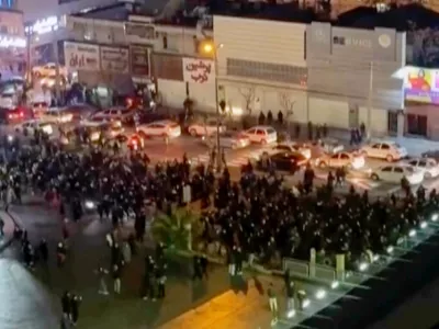 In this frame grab from video taken by an individual not employed by The Associated Press and obtained by the AP outside Iran shows people blocking an intersection during a protest in Tehran, Iran, Thursday Jan. 8, 2026. (UGC via AP)
