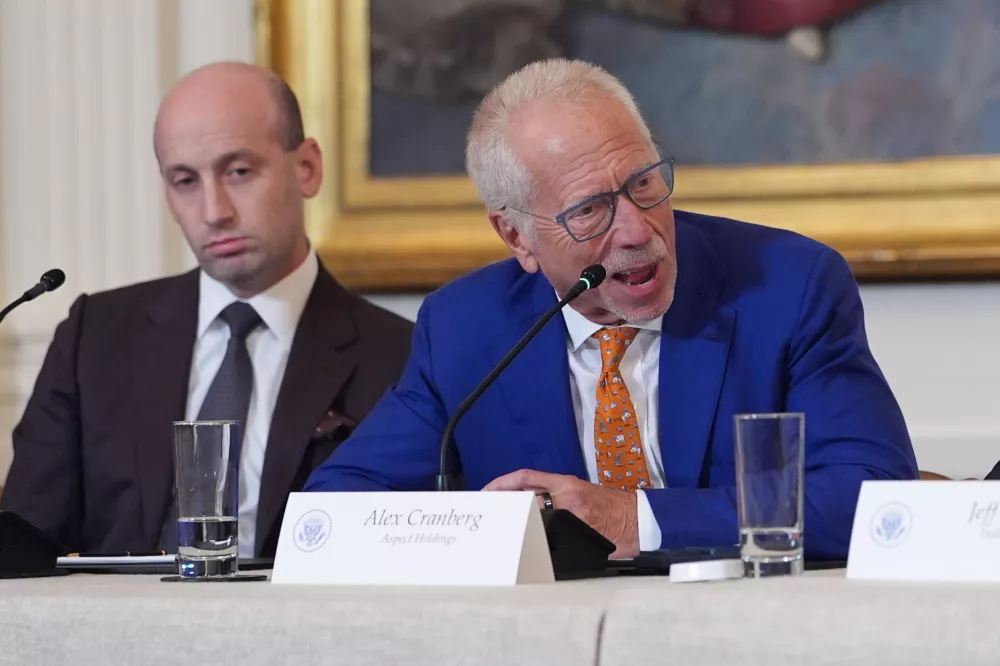 Alex Cranberg, chairman of Aspect Holdings, speaks as White House deputy chief of staff Stephen Miller listens, during a meeting with President Donald Trump and oil executives in the East Room of the White House, Friday, Jan. 9, 2026, in Washington. (AP Photo/Evan Vucci)