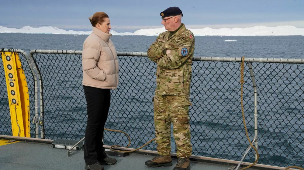 FILE PHOTO: Denmark's Prime Minister Mette Frederiksen talks with the head of the Arctic Command Soeren Andersen, aboard the Defense's inspection vessel Vaedderen in the waters around Nuuk, Greenland, April 3, 2025. REUTERS/Tom Little/File Photo