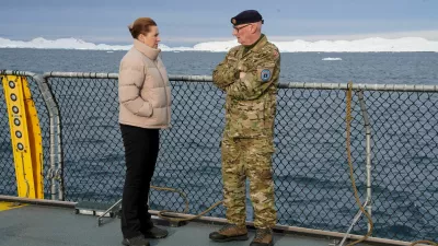 FILE PHOTO: Denmark's Prime Minister Mette Frederiksen talks with the head of the Arctic Command Soeren Andersen, aboard the Defense's inspection vessel Vaedderen in the waters around Nuuk, Greenland, April 3, 2025. REUTERS/Tom Little/File Photo