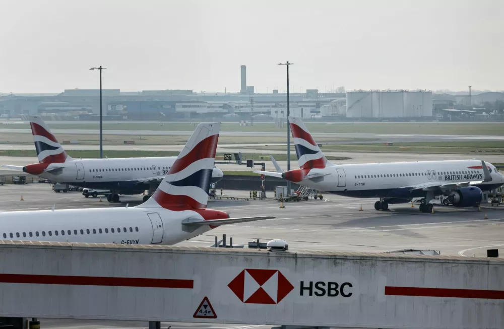 Airplanes remain parked on the tarmac at Heathrow International Airport after a fire at a nearby electrical substation wiped out the power at the airport, near London, Britain, March 21, 2025. REUTERS/Carlos Jasso