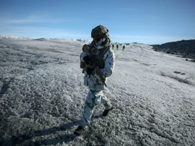 FILE PHOTO: A member of the French armed forces walks on ice during a military drill as Danish, Swedish and Norwegian home guard units together with Danish, German and French troops take part in joint military drills in Kangerlussuaq, Greenland, September 17, 2025. REUTERS/Guglielmo Mangiapane/File Photo