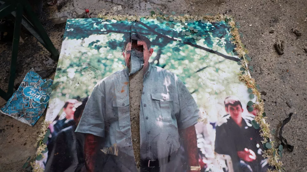 A defaced picture of Abdullah Ocalan, the imprisoned leader of the Kurdistan Workers' Party, or PKK, lies on the floor in the predominantly Kurdish Sheikh Maqsoud neighborhood in the northern city of Aleppo, Syria, Monday, Jan. 12, 2026, where clashes broke out on Jan. 6, between government forces and the Kurdish-led Syrian Democratic Forces. (AP Photo/Omar Albam)