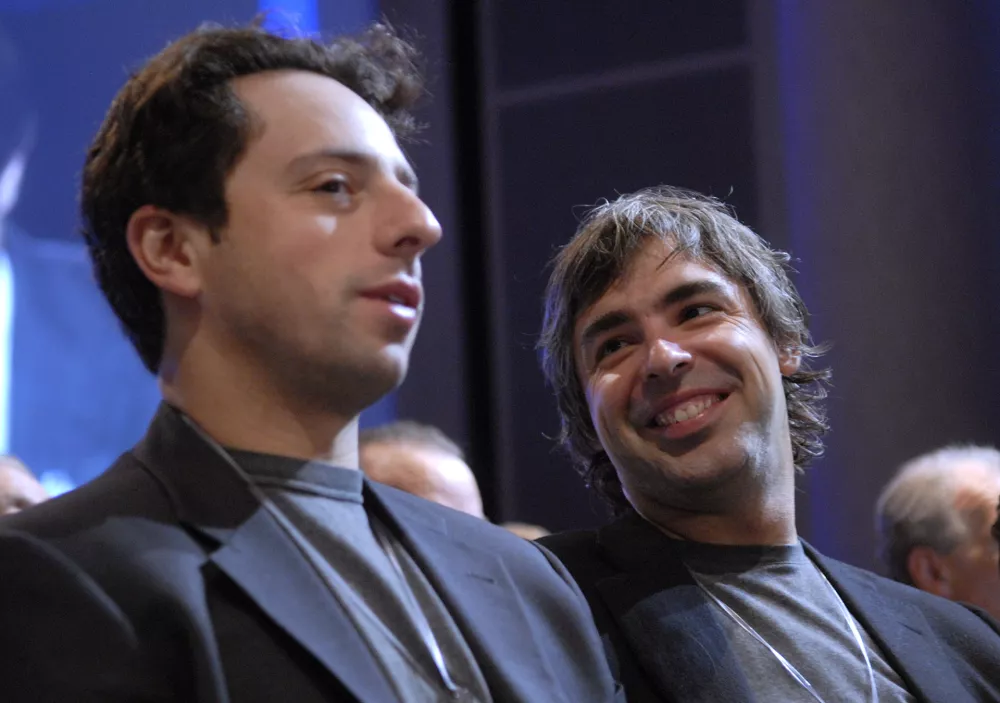 Google founders Larry Page and Sergey Brin are recognized for their efforts at the conclusion of the Clinton Global Initiative in New York, September 22, 2006. Former US President Bill Clinton's annual event brings together world leaders from business, government and philanthropy to try to solve world issues. REUTERS/Chip East (UNITED STATES)