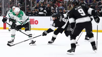 Dallas Stars left wing Jason Robertson (21) shoots against Los Angeles Kings defenseman Drew Doughty (8) as right wing Adrian Kempe (9) watches during the third period of an NHL hockey game, Monday, Jan. 12, 2026, in Los Angeles. (AP Photo/Jessie Alcheh)