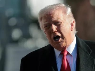 U.S. President Donald Trump speaks to reporters, on his way to the Marine One helicopter to depart the White House for travel to Detroit, Michigan, in Washington, D.C. U.S. January 13, 2026. REUTERS/Jonathan Ernst