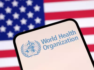 FILE PHOTO: World Health Organization (WHO) logo and U.S. flag are seen in this illustration taken April 23, 2025. REUTERS/Dado Ruvic/Illustration/File Photo