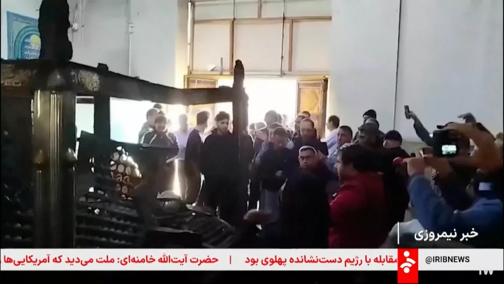 People gather at Sabzqaba Shrine that was damaged following unrest sparked by dire economic conditions, in a place given as Dezful, Iran, January 9, 2026, in this screengrab from Iran's state media broadcast footage. IRIB via WANA(West Asia News Agency) via REUTERS ATTENTION EDITORS - THIS PICTURE WAS PROVIDED BY A THIRD PARTY. IRAN OUT. NO COMMERCIAL OR EDITORIAL SALES IN IRAN NO USE BBC PERSIAN. NO USE VOA PERSIAN. NO USE MANOTO. NO USE IRAN INTERNATIONAL. NO USE RADIO FARDA. FOR REUTERS CUSTOMERS ONLY. TEXT OVERLAY FROM SOURCE.