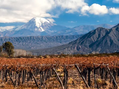 Volcano Aconcagua and Vineyard. Aconcagua is the highest mountain in the Americas at 6,962 m (22,841 ft). It is located in the Andes mountain range, in the Argentine province of Mendoza
