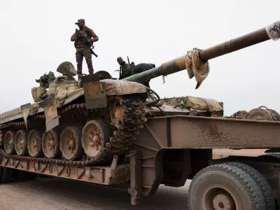 A member of the Syrian army stands over a tank, following the withdrawal of Kurdish-led Syrian Democratic Forces (SDF), in Maskanah, near Aleppo, Syria, January 17, 2026. REUTERS/Mahmoud Hassano